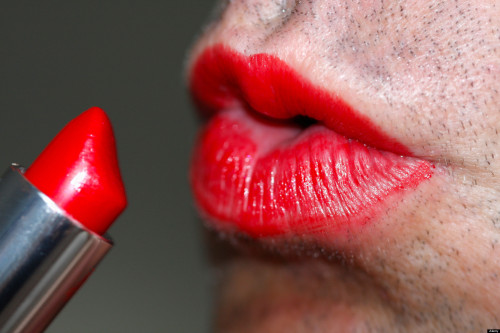Man applying red lipstick. Image shot 2010. Exact date unknown.